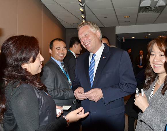 Mr. Terry McAuliffe is having a cordial talk with Chinese entrepreneurs